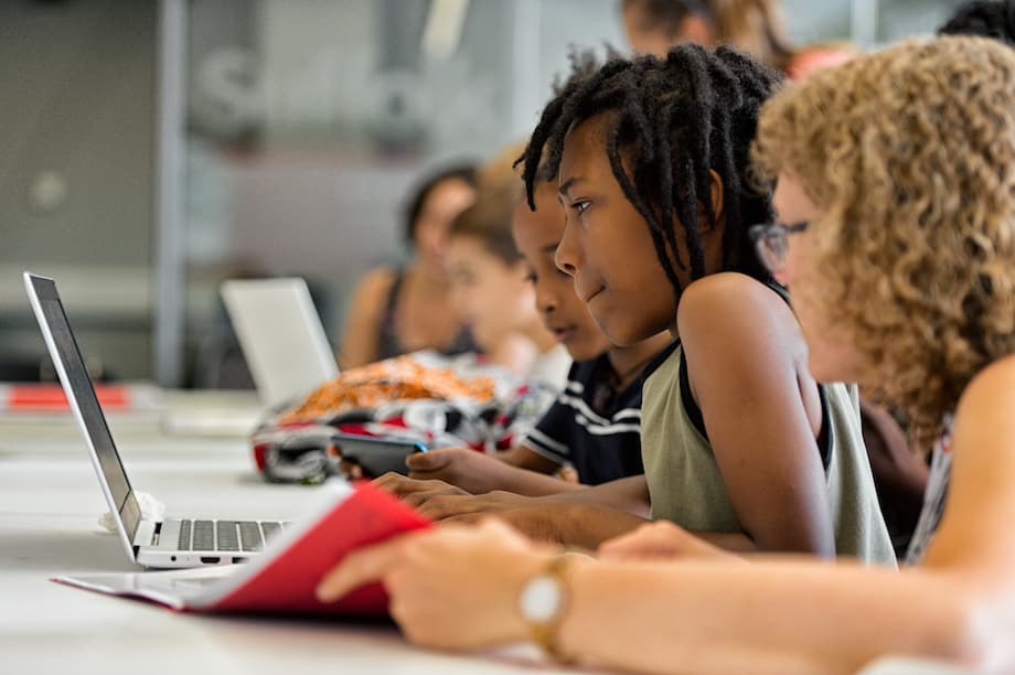 A girl concentrating at a laptop.