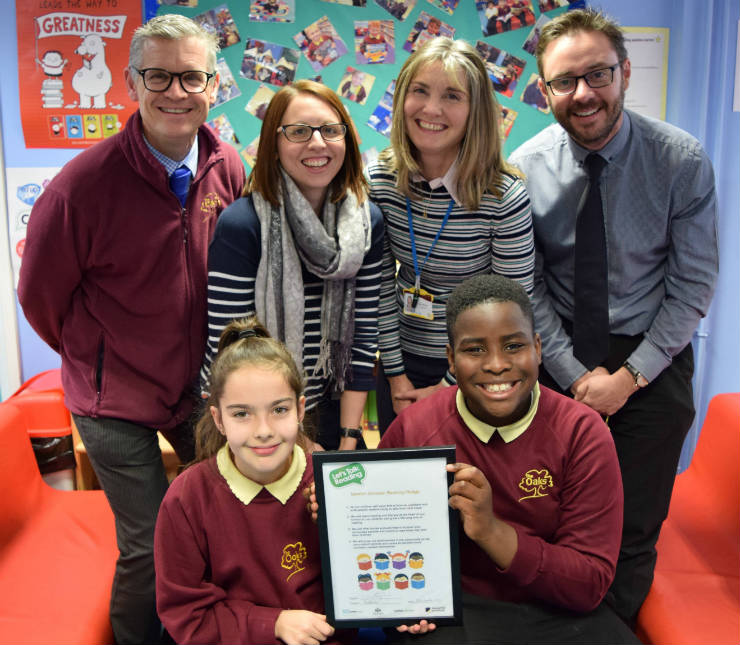 4 teachers and 2 pupils display a certificate