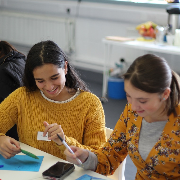 Two girls working on artworks at Ipswich County Library