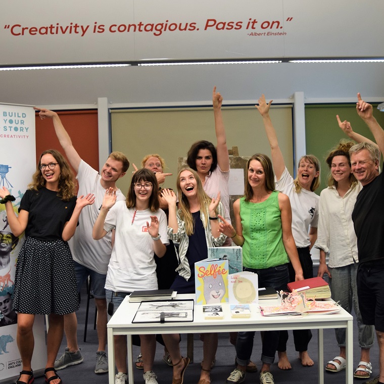 People cheering behind a desk