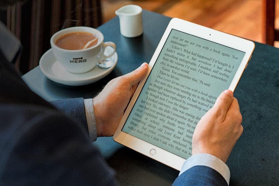 Man in a suit reading an eBook.