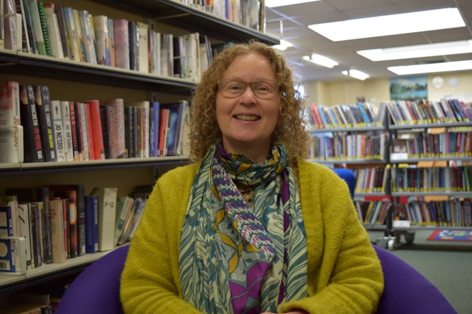 Angie Lee Foster sat in a library.