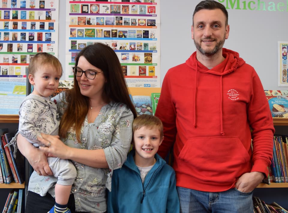 Sarell Payne and family in a library.