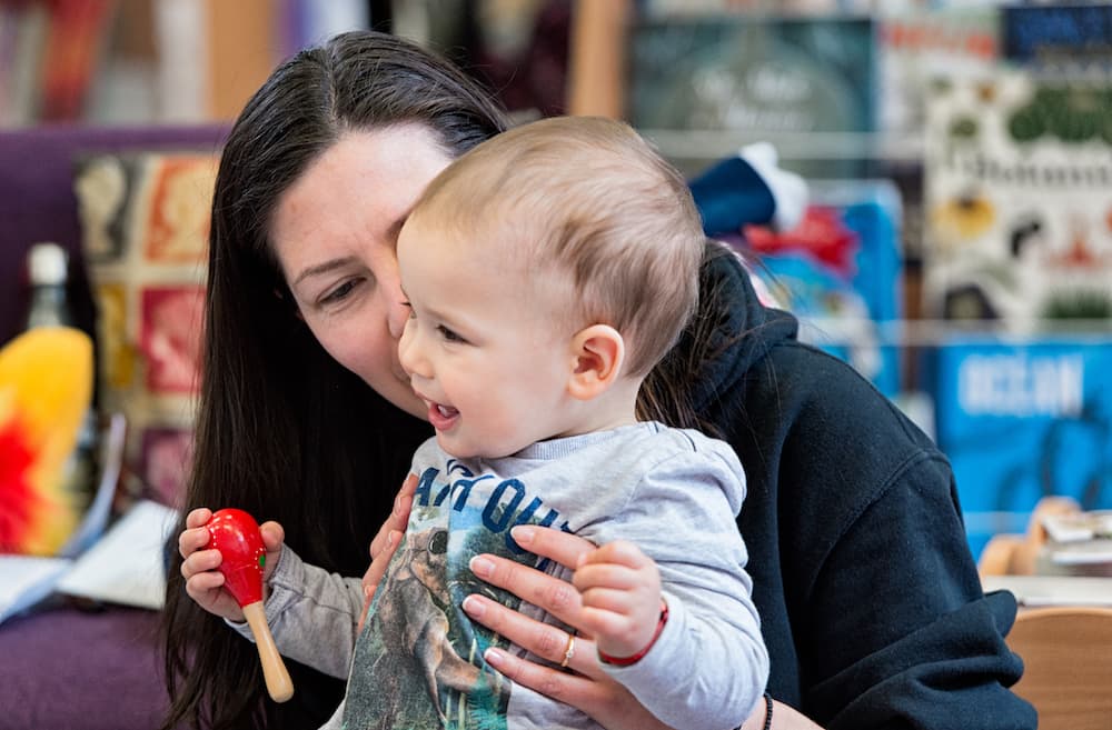 Woman playing with her baby in a library.