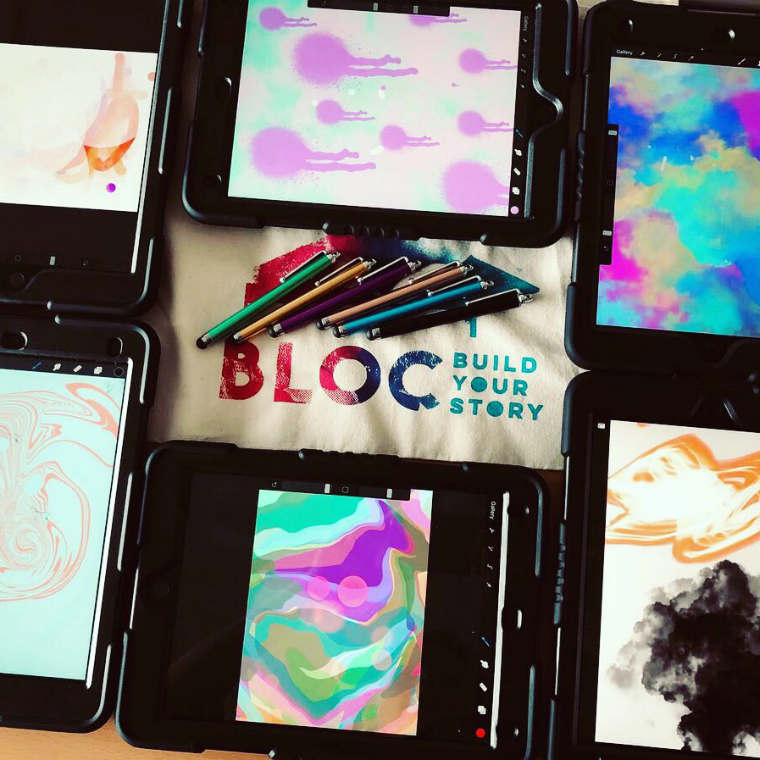 Colourful artworks on iPads surrounding the BLOC logo and some styluses