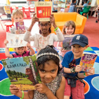 Children holding up books that are popular with Suffolk Libraries readers