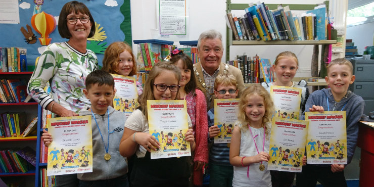 Children at Needham Market Library receive their Summer Reading Challenge certificates and medals from Deputy Mayor Steve Phillips and library manager Donna Grand.