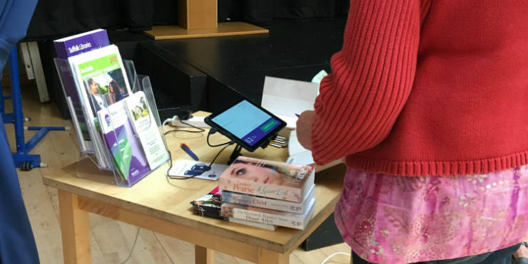 Suffolk Libraries Local customers self-issuing books using a tablet