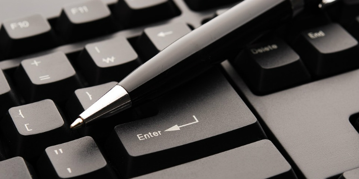 A pen on a computer keyboard