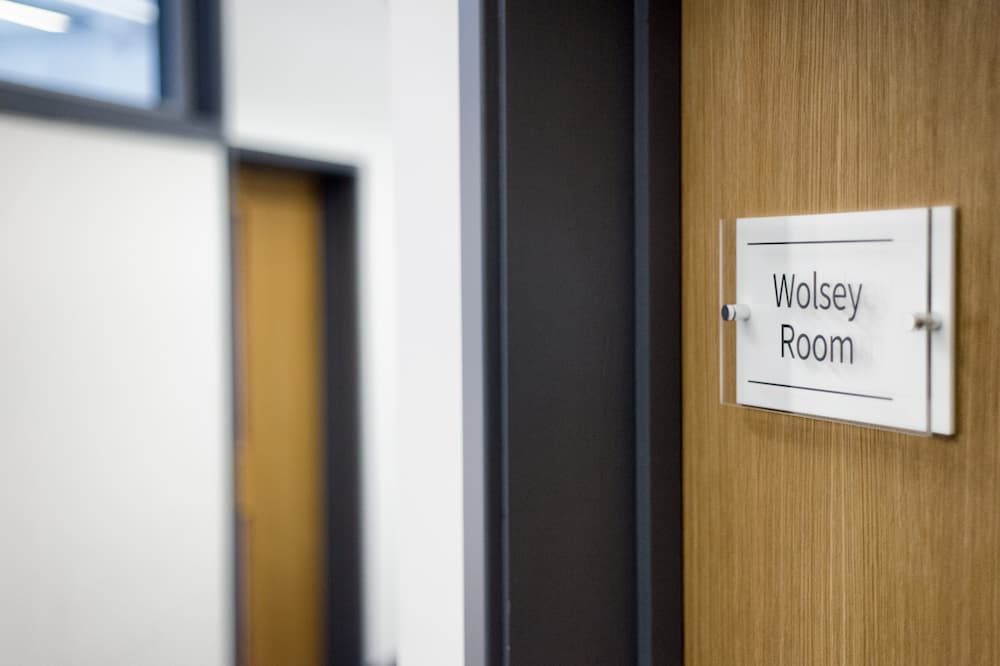 A sign on a door saying 'Wolsey Room'.